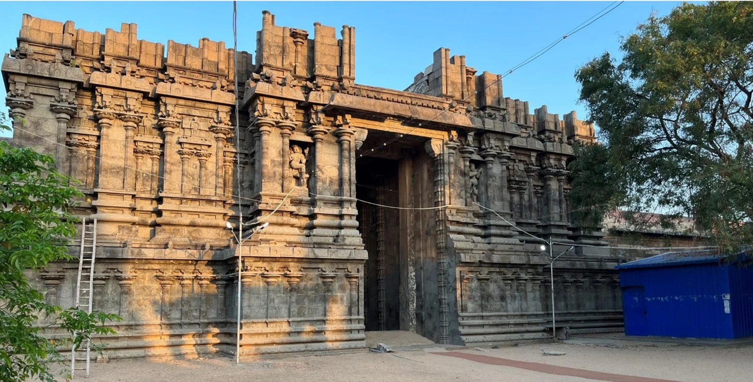 Monumental stone temple gopuram gateway at golden hour.