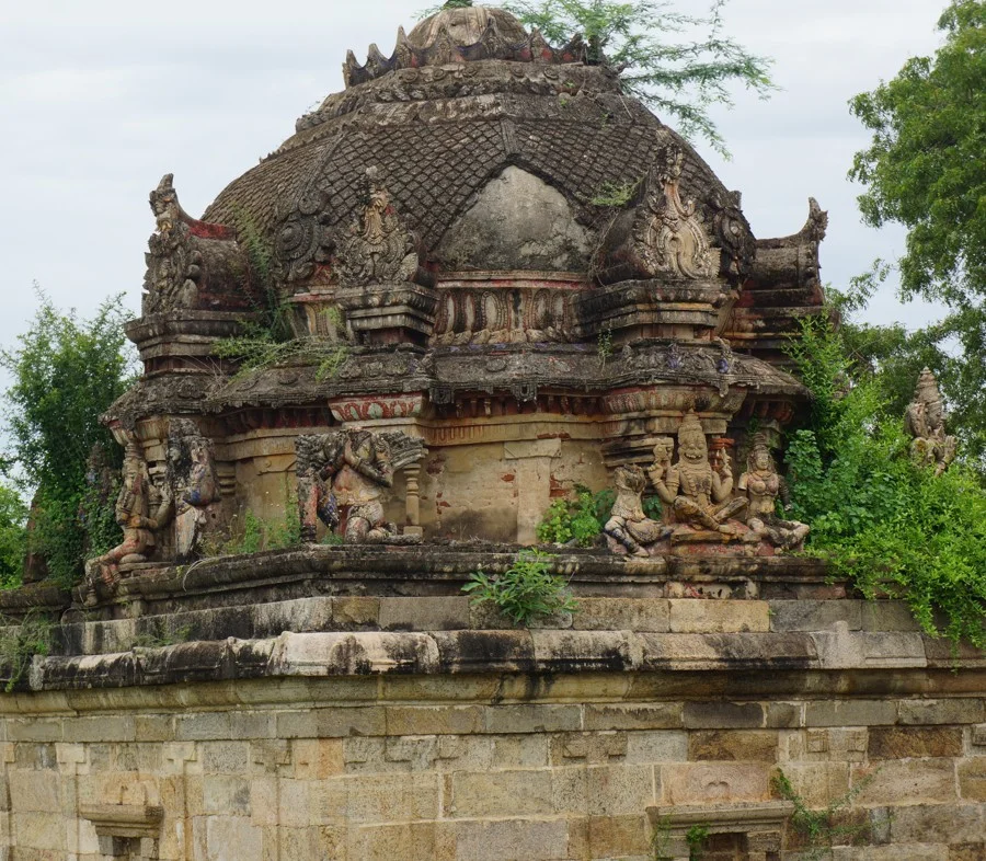 Detail of sculpted stucco figures and decorative architectural tiers on temple superstructure.